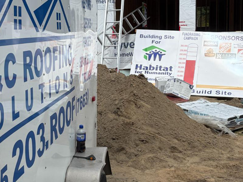 C&C Roofing Solutions truck at a Parry Sound roofing site for Habitat for Humanity